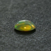 ETHIOPIAN OPAL PLAIN OVAL CAB (YELLOWISH BASE/MULTI POWER MILKY) 7.00X5.00 MM 0.46 CTS