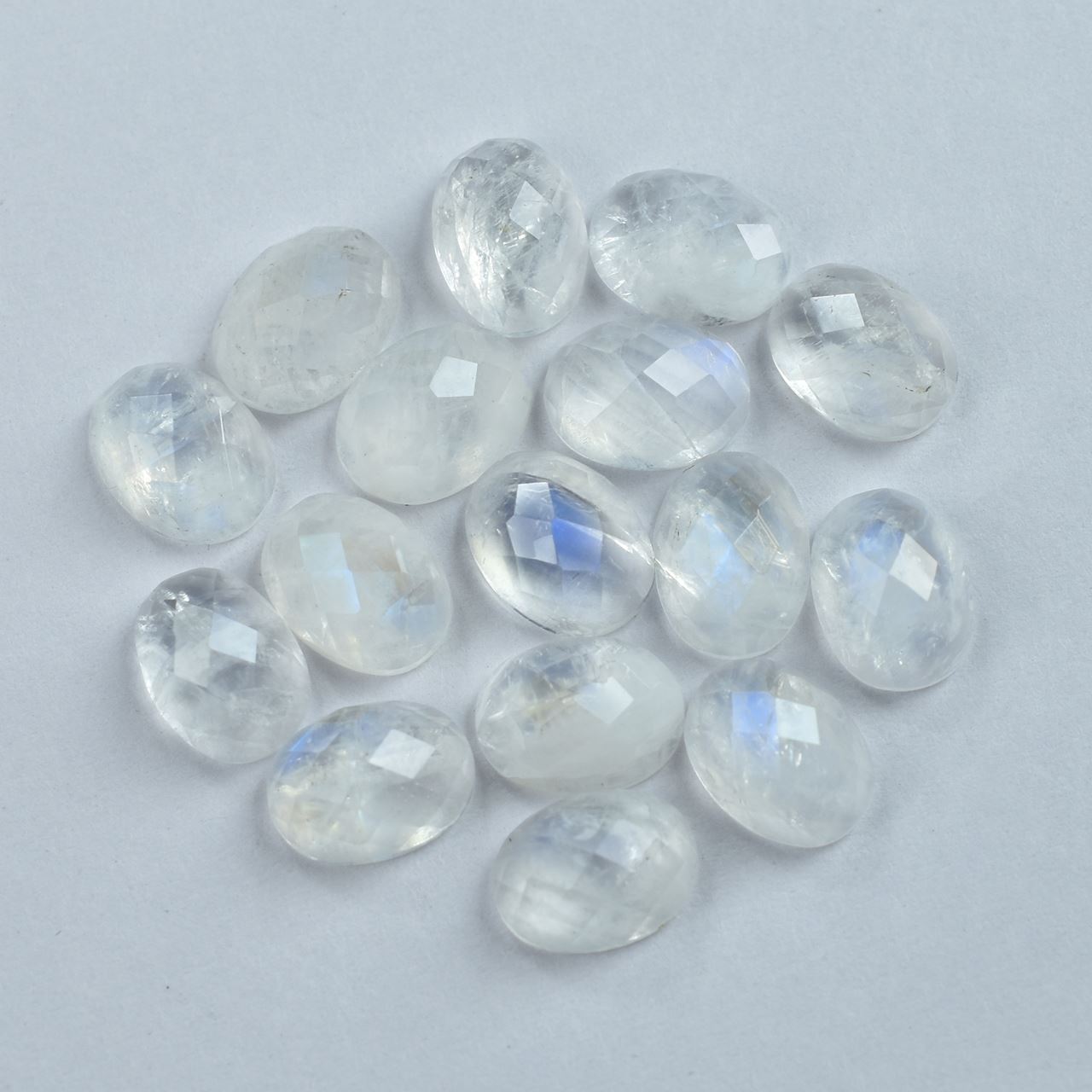 RAINBOW MOONSTONE CHECKER CUT OVAL CAB (SEMI CLOUDY)(NICE BLUE SHINE) 8.00X6.00 MM 1.22 Cts.