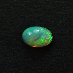 ETHIOPIAN OPAL PLAIN OVAL CAB (YELLOWISH/MULTI POWER) 6.00X4.00 MM 0.26 CTS