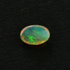 ETHIOPIAN OPAL PLAIN OVAL CAB (YELLOWISH/MULTI POWER) 6.00X4.00 MM 0.26 CTS