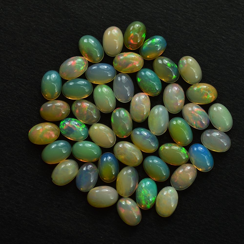 ETHIOPIAN OPAL PLAIN OVAL CAB (YELLOWISH/MULTI POWER) 6.00X4.00 MM 0.26 CTS