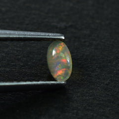 ETHIOPIAN OPAL PLAIN OVAL CAB (YELLOWISH/MULTI POWER) 5.00X3.00 MM 0.12 CTS