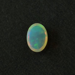 ETHIOPIAN OPAL PLAIN OVAL CAB (YELLOW BASE/BLUE GREEN POWER) 7.00X5.00 MM 0.48 CTS