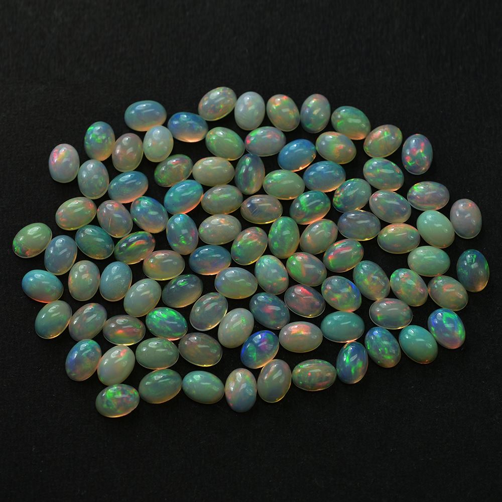 ETHIOPIAN OPAL PLAIN OVAL CAB (YELLOW BASE/BLUE GREEN POWER) 7.00X5.00 MM 0.48 CTS