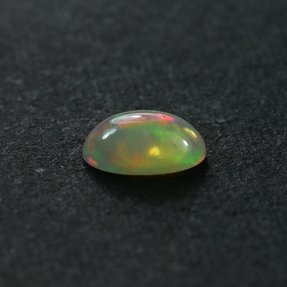 ETHIOPIAN OPAL PLAIN OVAL CAB (OFF WHITE /MILKY/RED GREEN POWER) 8.00X6.00 MM 0.75 CTS