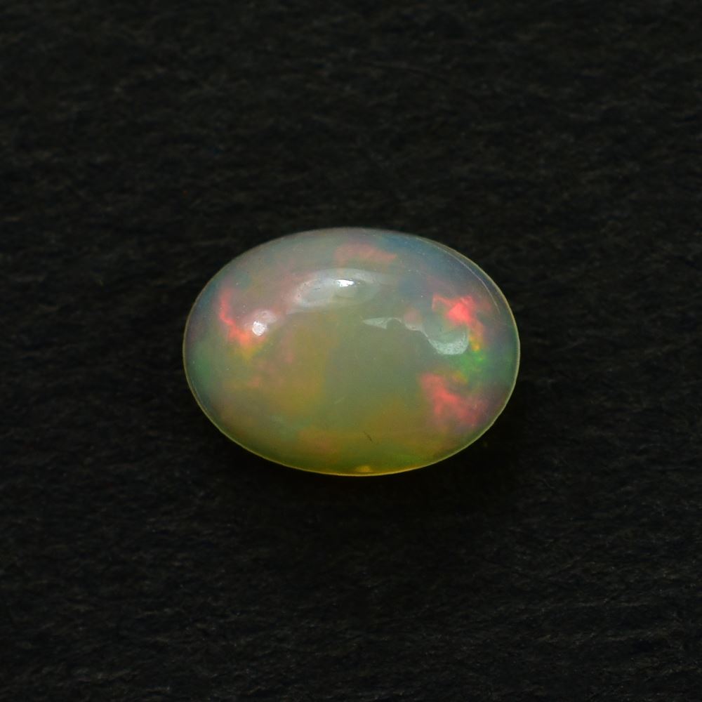 ETHIOPIAN OPAL PLAIN OVAL CAB (YELLOWISH BASE/MULTI POWER MILKY) 7.00X5.00 MM 0.46 CTS