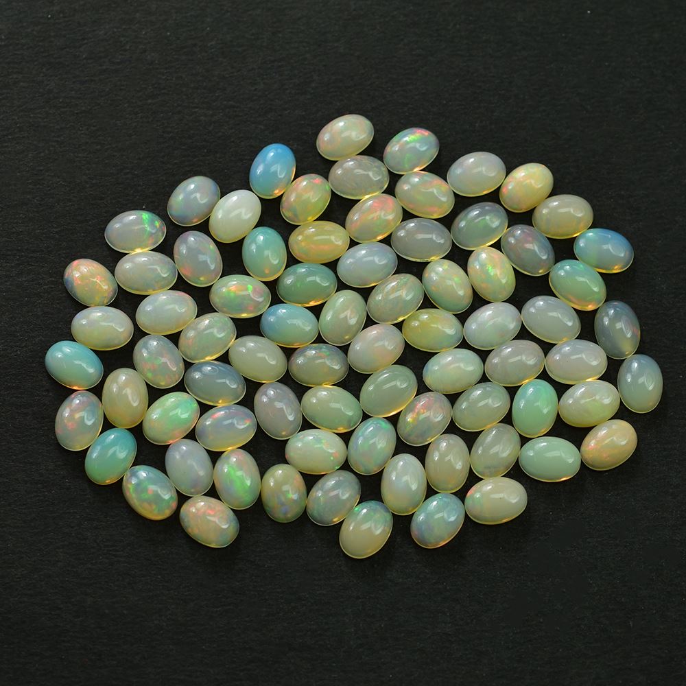 ETHIOPIAN OPAL PLAIN OVAL CAB (YELLOWISH BASE/MULTI POWER MILKY) 7.00X5.00 MM 0.46 CTS