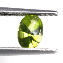 PERIDOT BUFFTOP OVAL WITH TWISTED CONCAVE BACK OVAL (DES#31) 6X4MM 0.60 Cts.